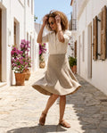 Woman walking in the neutral tweed stitch knit skirt