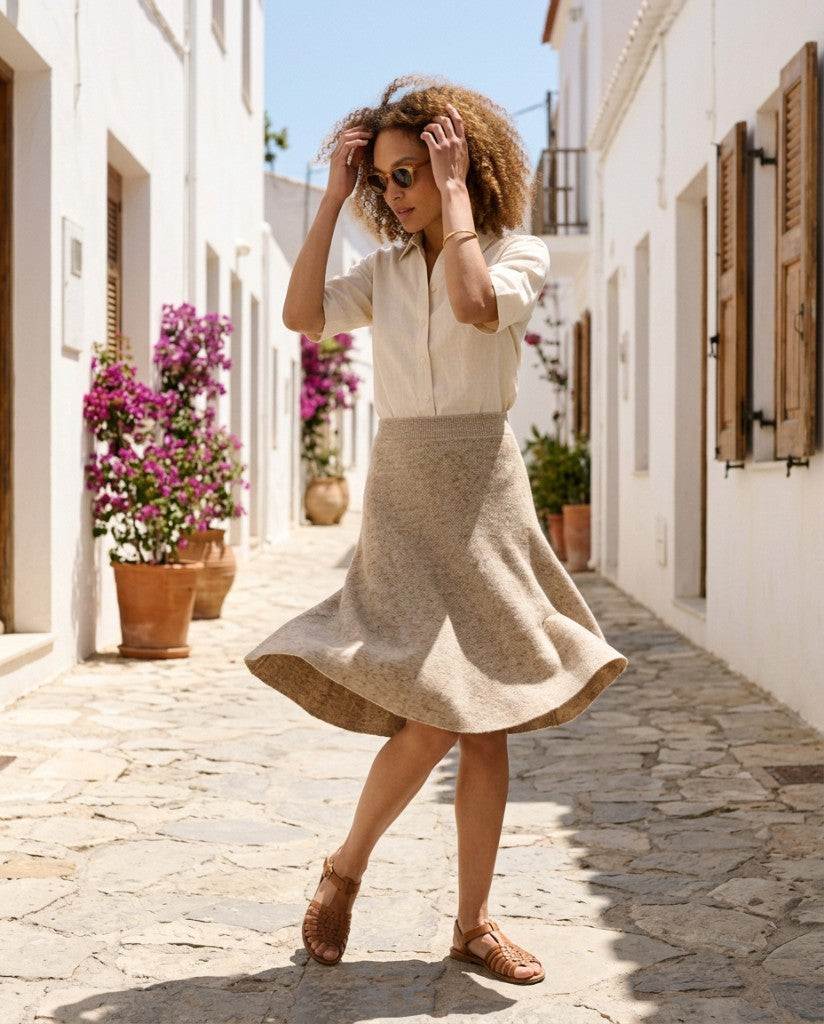 Woman walking in the neutral tweed stitch knit skirt